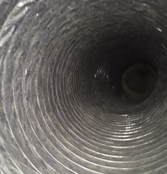 Same air duct after cleaning, clear metal visible
